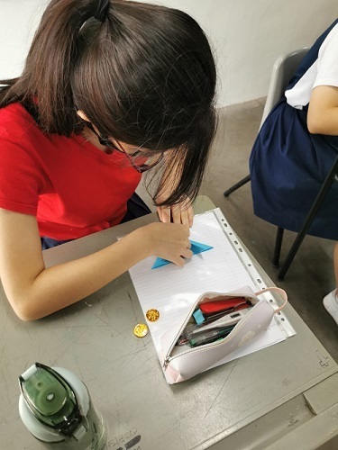 Student enjoying the fun of origami